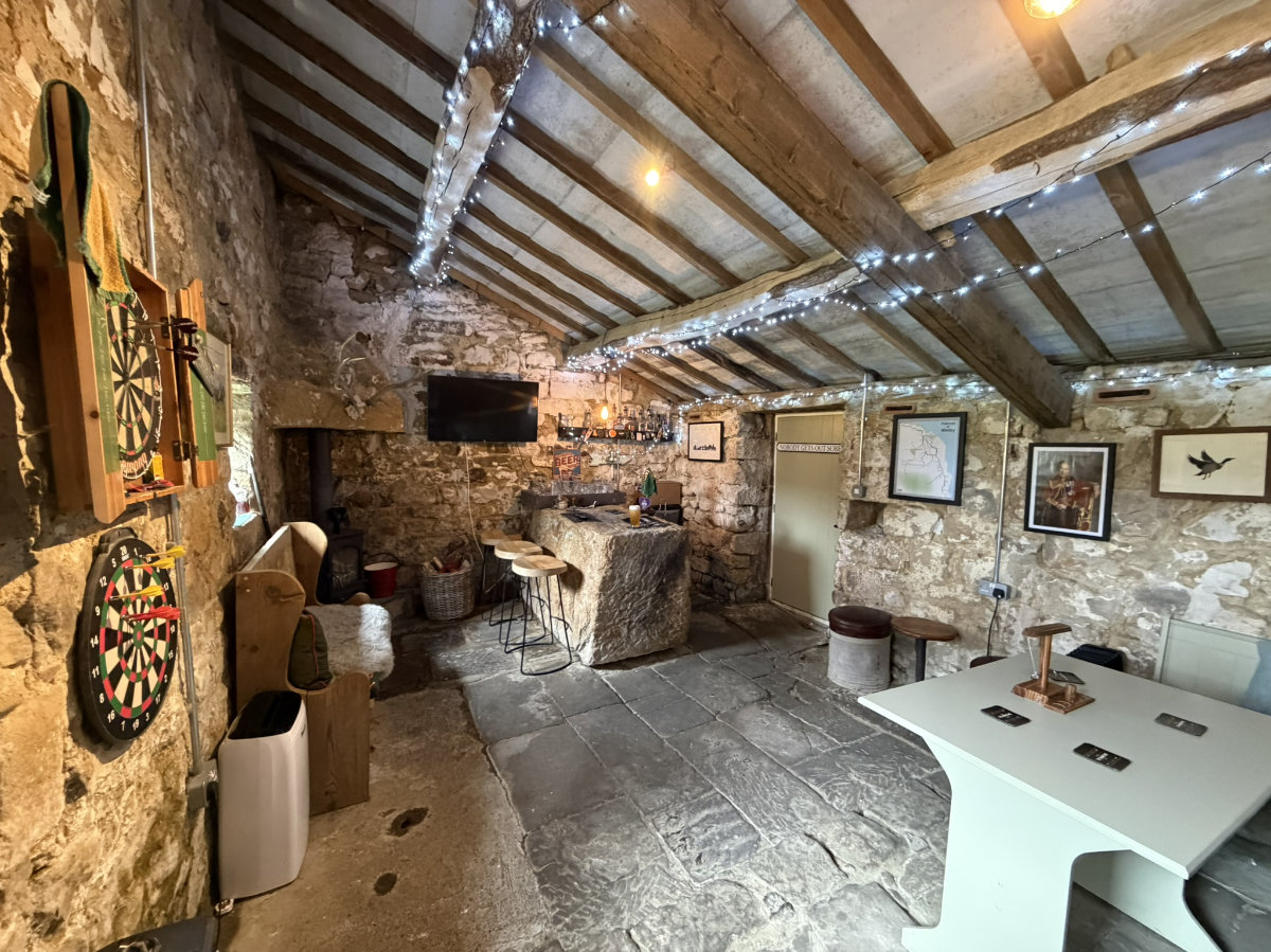 The stone bar and wood-burning stove inside The Stumble Inn
