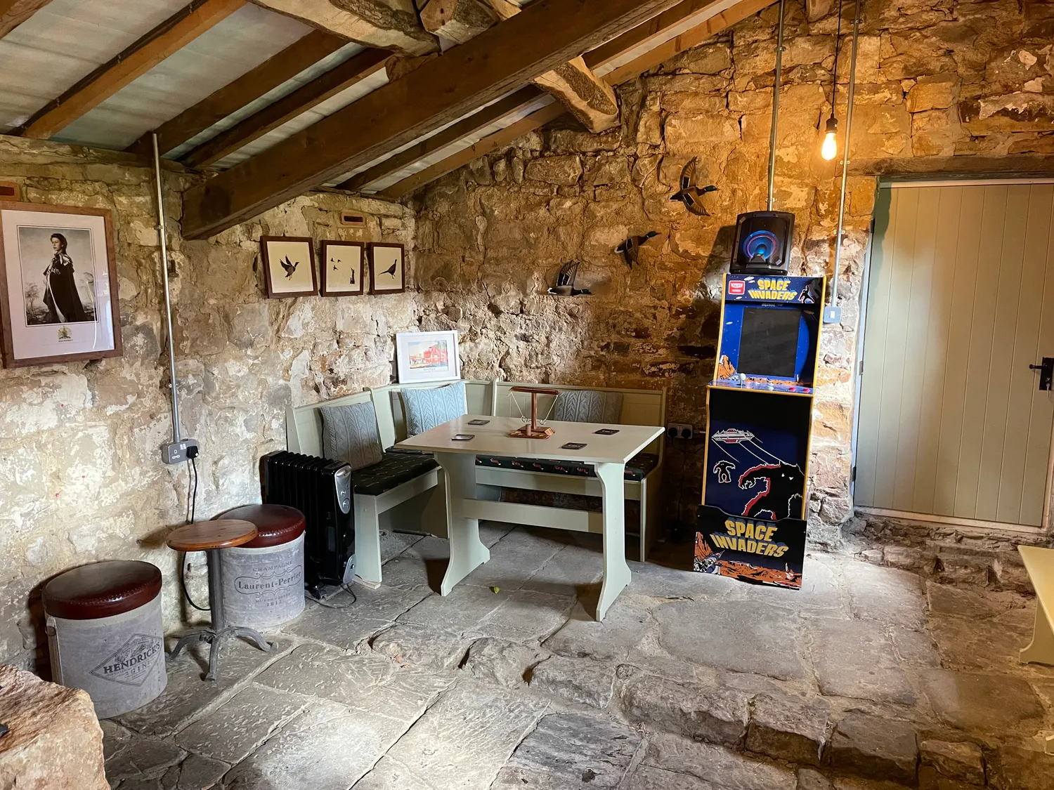 The seating and arcade machine inside The Stumble Inn